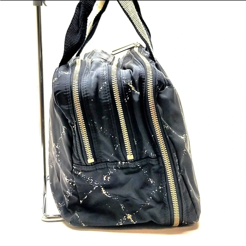 CHANEL Cream and Black Travel Bag with Elegant Design